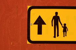 Sign with adult holding child's hand