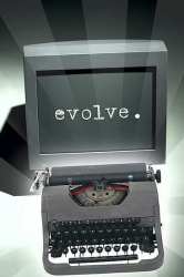 Computer monitor with antique typewriter. Monitor displaying "evolve."