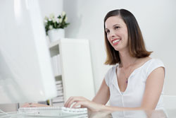 Smiling woman at computer