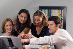 Group collaborating at computer