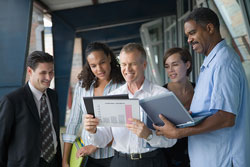 Group with laptop and chart