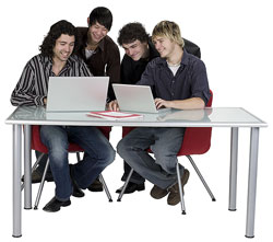 Four young men working with laptops