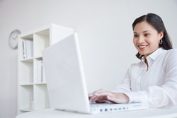Smiling woman at computer