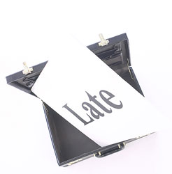 "Late" on a sign in a briefcase