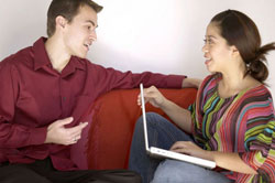 Man and woman sitting on couch chatting