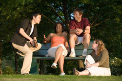 Multiracial group of friends hanging out at park