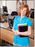 Teacher holding books.