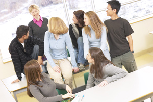 Teacher surrounded by a group of middle school students