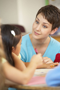 Teacher conversing with young girl