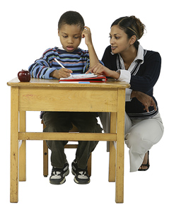 Teacher assisting student at his desk