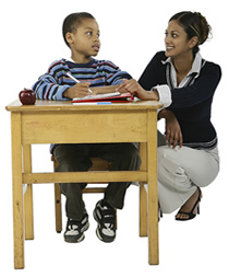 Teacher helping student at desk